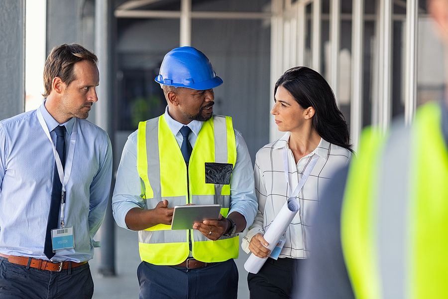 A group of people talking at a construction site