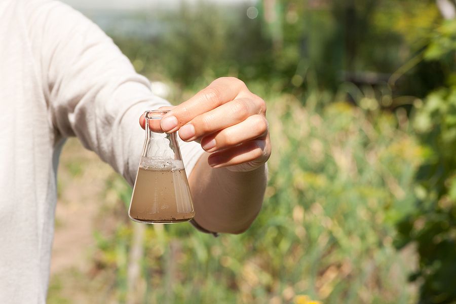 Close up image of dirty water in a glass vial