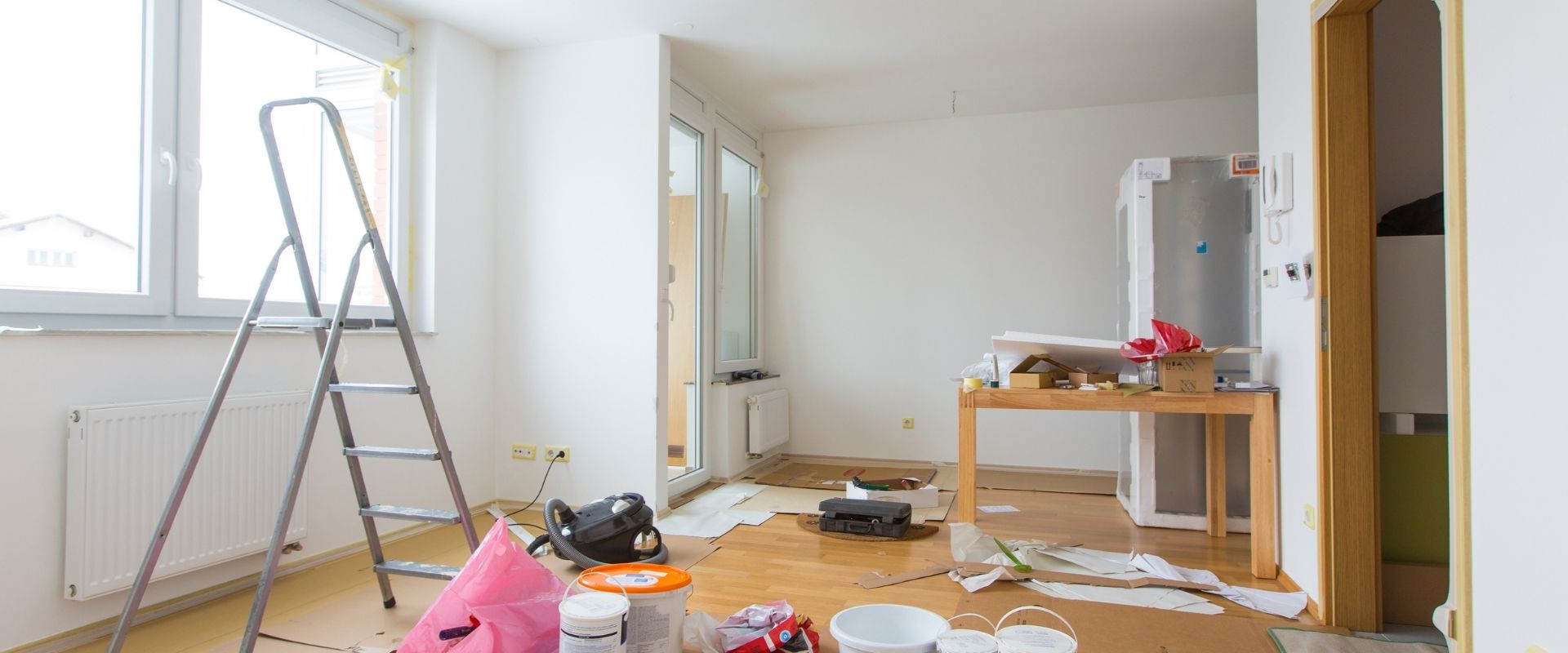 A room in the middle of renovation with paint and other chemicals exposed.