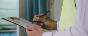 Environmental inspection depicted by a man with a clipboard and pencil