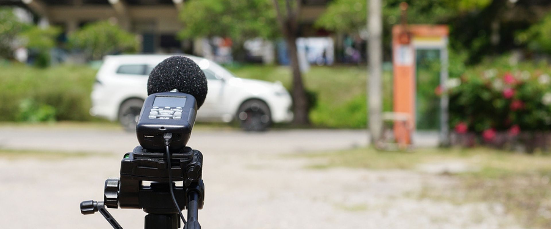 Measuring the noise on the road with a sound level meter.