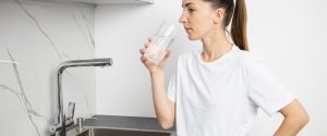 Woman drinking water at risk of saltwater intrusion contamination