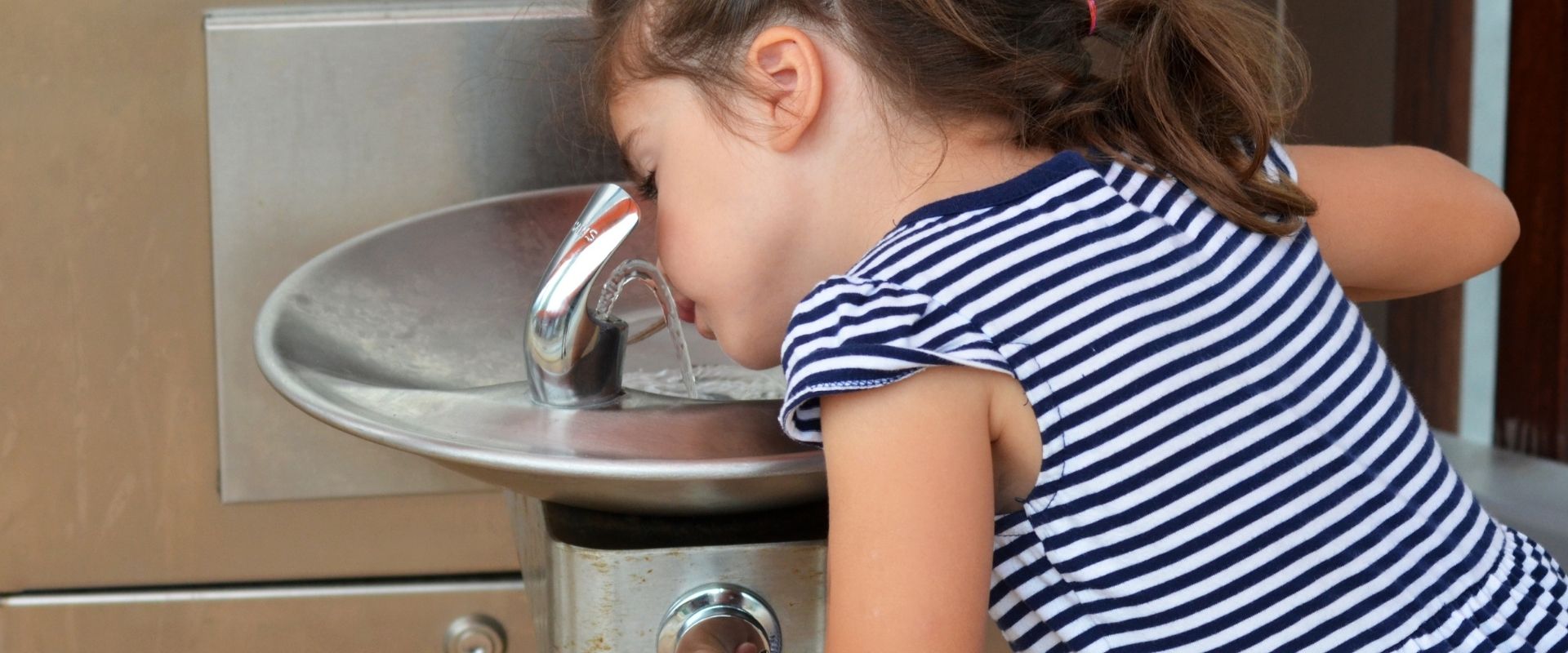 Child Drinking From Outdoor Water Fountain